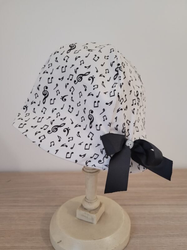 Chapeau cloche imprimé notes de musique sur fond blanc